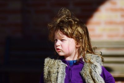 Close-up of girl looking away in warm clothes