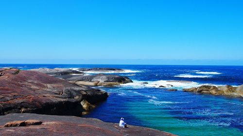 Scenic view of sea against clear blue sky