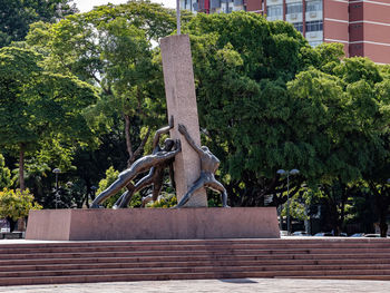 Statue in park against building