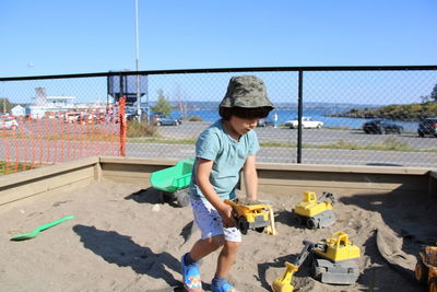 Portrait of boy playing with toy car