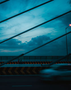 Bridge over river against sky at dusk