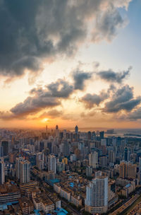 High angle view of buildings in city against sky during sunset