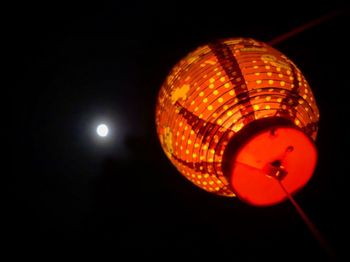 Low angle view of illuminated ferris wheel against sky at night