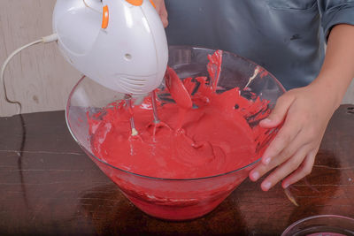 Midsection of chef preparing food in bowl