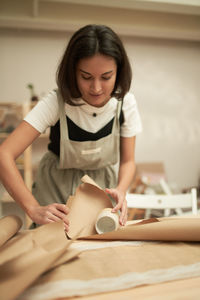 Young woman sitting on table