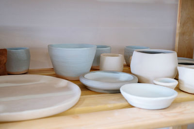 Pottery plates and bowls drying out waiting to be glazed