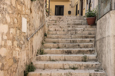 Low angle view of steps amidst buildings