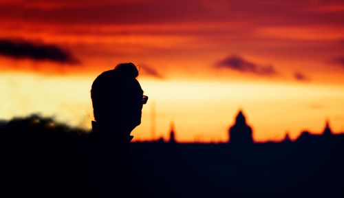 Silhouette man against orange sky during sunset