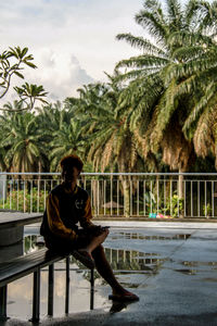 Woman looking at swimming pool against sky