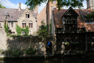 Old building by street in city