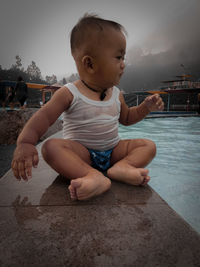 Cute boy looking at swimming pool