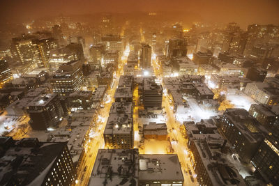 High angle view of illuminated buildings in city at night