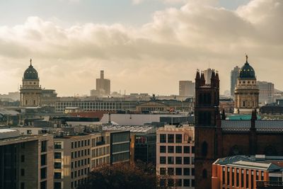 High angle view of buildings against cloudy sky