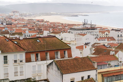 High angle view of townscape by sea