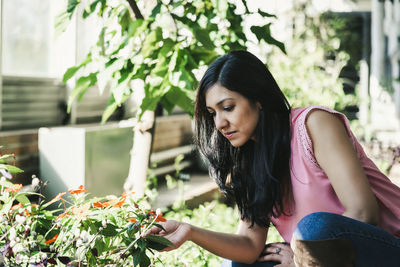 Beautiful young woman sitting in pot