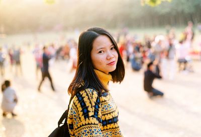 Portrait of young woman standing outdoors