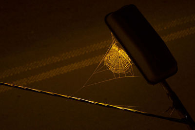 Close-up of illuminated light bulb on table