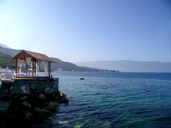 Scenic view of bay against clear sky