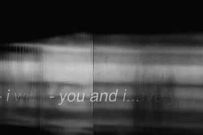 Close-up of text on glass window