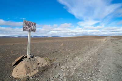 Scenic view of landscape against blue sky