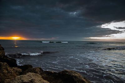 Scenic view of sea against dramatic sky