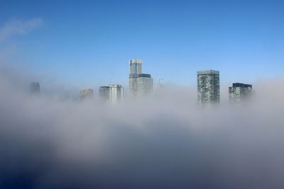 Modern buildings in city against sky