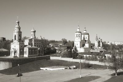 Churches in city against clear sky