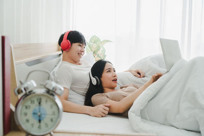 Woman relaxing on bed at home