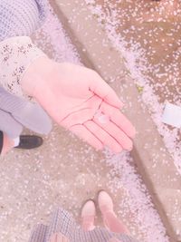 Low section of woman with pink umbrella