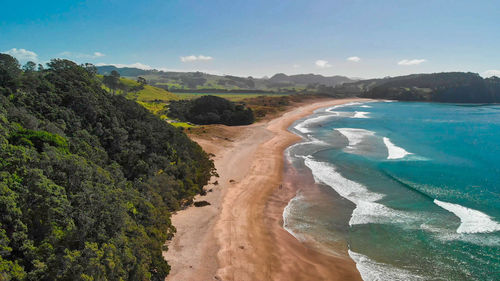 Scenic view of land and sea against sky