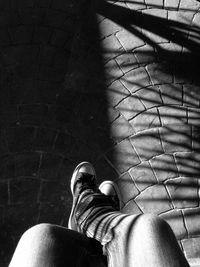 Low section of woman standing on tiled floor