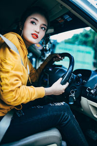 Young woman sitting in car