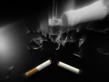 Close-up of man smoking on table