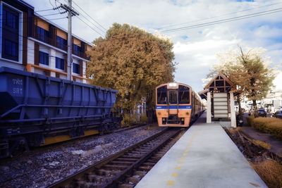 Train at railroad station against sky