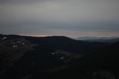 Scenic view of silhouette mountains against sky at sunset