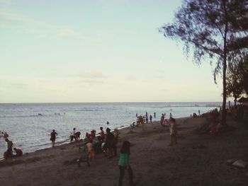 People on beach against sky