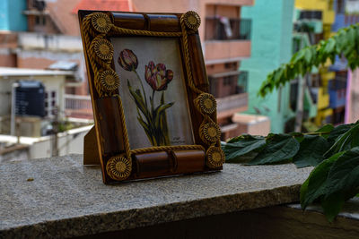 Close-up of buddha statue on table against building