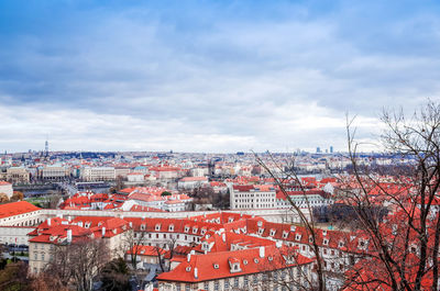 View of cityscape against cloudy sky