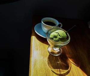 High angle view of green tea ice cream cup on table