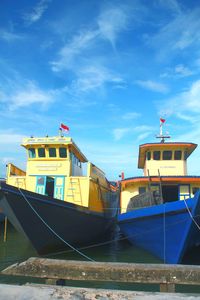 Boat moored on sea against sky