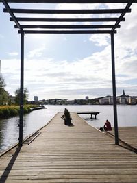 Pier over river against sky