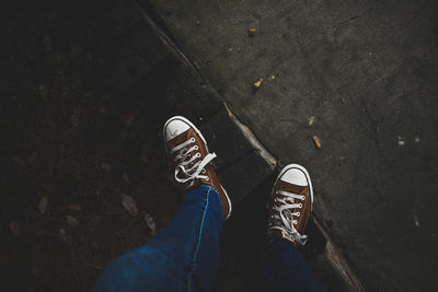 Low section of man standing on footpath