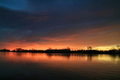 Scenic view of lake at sunset