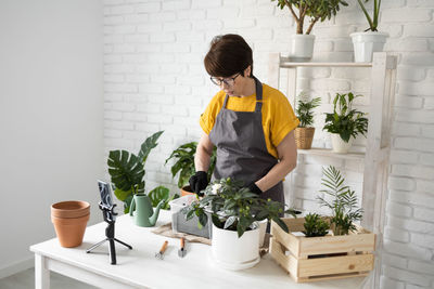 Side view of woman gardening at home