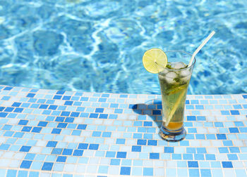 Close-up of drink on table at swimming pool