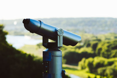 Close-up of camera on field against sky