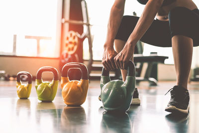 Woman exercising with kettlebell in gym