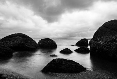 Rocks in sea against sky