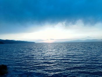 Scenic view of sea against cloudy sky