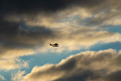 Low angle view of airplane flying in sky